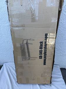 lot 8 image: Park bench 30T x 47.5W x 18.1D Black metal. Still in box.&nbsp