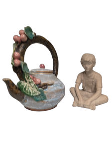 lot 74 image: FLORAL TEAPOT &amp LITTLE BOY GARDEN STATUE BY AUSTIN PRODUCTIONS - Ceramic floral designed teapot. 10T x 85W x 7D. Little boy sitting made of concrete garden statue. By Austin Productions. Measures 7T x 5.5W x 5D.