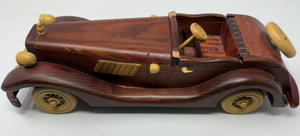 lot 41 image: VTG STYLE WOODEN CAR DECOR. ONE SEAT, NO WINDSHIELD. RICH, DARK WOOD FINISH .&nbsp PLASTIC LIIGHTS, WHEELS, STEERING COLUMN, &amp SPARE ALL A CAMEL COLOR THAT CONTRASTS NICELY WITH THE WOOD.&nbsp&nbsp