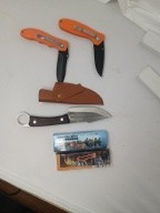 lot 65 image: 3 KNIFES - Knife with brown case. 9L x 1.5W. Never been used. 2 orange knifes 4.5.