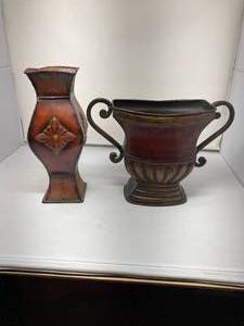 lot 54 image: 2 VASESDCOR - 2 piece vases in excellent condition. Tall one is 13T x 5W x 5D orange and black. The shorter one in 9.5T x 13W x 5D. Dark Red, Gold and Black Large handles, one on each side.