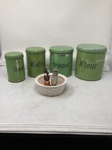 lot 256 image: 4 Items  Stainless Steel 5 oz Flask. Set of 4 Nesting,  Green, Kitchen Counter Cannisters.  Small one has a couple of small dents. One 6D white bowl.  Small bell with western theme above it.