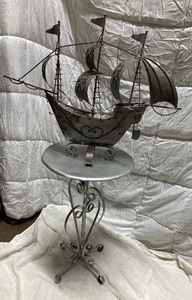 lot 204 image: VINTAGE METAL SHIP AFFIXED TO A METAL BASE. BOTH ARE SILVER IN COLOR. A VERY UNIQUE CONVERSATION OR CENTER PIECE 55T x 31W.