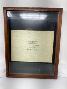 lot 205 image: SHADOW BOX WITH WOOD FRAME AND BLACK FOR THE BACKDROP INSIDE. 17T x 13W.