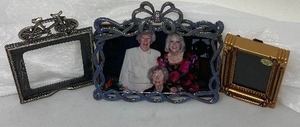 lot 264 image: 3 Small Picture Frames  1) Bronze, Wall-Hanging, 3,3 x 2.6.  2) GraySilver Frame without a back.  3.5 x 3.5   3) BlueGray Desk Photo Frame Has bejeweled Ring on the Bow Atop the Frame