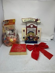 lot 289 image: 4-Part Lot. 1) TAZ in a Bag With Easter Eggs.  2) A Decorative Welcome Sign For Front Door 3) An Empty Decorative Godiva Chocolate Box  4) An 11.5 Wide Decorative Bow