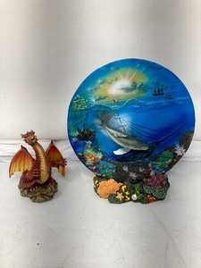 lot 295 image: 3-Piece Lot.  Use your imagination. One piece is a little dragon on a rock, second is a bright blue nautical motif on a plate. Finely, there is a plate holder that is the perfect match for the plate ( 7.7 diameter).
