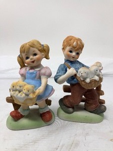 lot 167 image: 2-Piece Lot Ceramic Boy &amp Girl Holding Baskets of Puppies  &amp Kittens. 5T x 3W x 2.5D