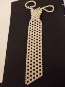 lot 140 image: Pearl beaded necklace (mens Tie theme)