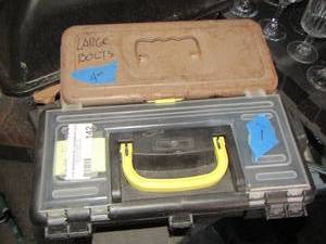 lot 142 image: small tan tool box with large bolts, black small toll box