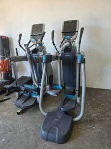 lot 100 image: Lot of 2 Precor AMT 12 885 Open Stride Elliptical Trainers w Touchscreen.  SEE DETAILS FOR MORE INFORMATION ABOUT THESE ITEMS