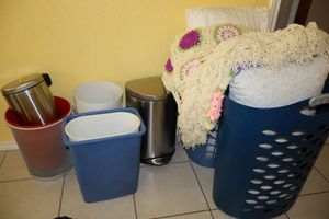lot 151 image: Laundry baskets, pillows, afghan blanket and trash cans