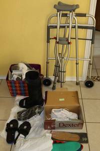lot 158 image: Walker, crutches, medical boots, masks, and womens shoes size 8