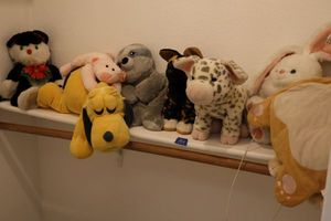 lot 164 image: Stuffed animals - includes plush cat heating pad with USB cord and weighted sloth