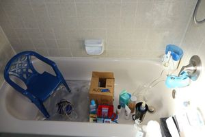 lot 146 image: Alcohol bottles (for cleaning), bandages, Water Pik, fish tank oxygenator, child size chair and more