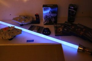 lot 123 image: Star Wars lot Light saber, movies, travel mug and toys