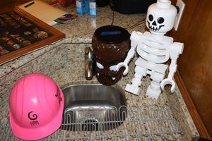lot 30 image: Lego skeleton, Wolfman container, hard hat and wire rack