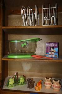 lot 47 image: Salt and pepper shakers, veggie food container, and cat food can dispensers