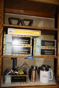 lot 48 image: Cigar boxes and matches, iron eyeglasses, and travel mugs