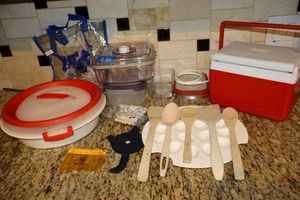 lot 45 image: Pie carrier, deviled egg plate, cat coasters, wooden spoons and personal cooler