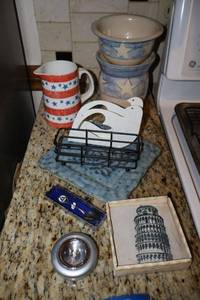 lot 50 image: Red, white and blue stars pottery, napkin holders, Space shuttle souvenir spoon, and thirsty stone coasters