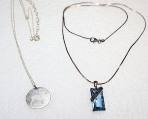 lot 265 image: Jewelry Looks like blue topaz pendant necklace. Two dog cut out pendant necklaces. Both necklaces marked 925