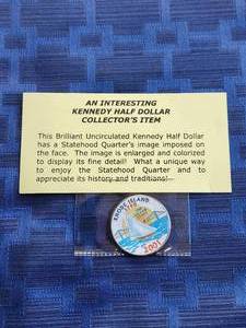 lot 26 image: Brilliant uncirculated Kennedy half dollar with statehood quarters image imposed on the face