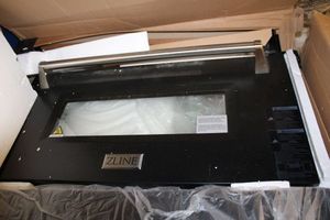 lot 112 image: Zline range door part # RA-DR-BLM-36 (glass needs repair)