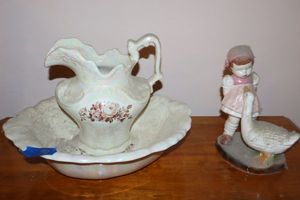 lot 90 image: Pitcher and basin set with porcelain figurine