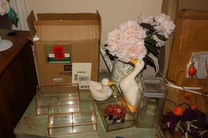 lot 129 image: Pink coffeetea set, flower arrangement, glass organizers, and duck figurines