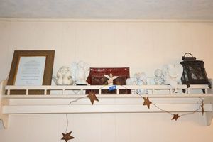 lot 138 image: Wall shelf, angel figurines, Tinkerbell ornament, and red glass plates