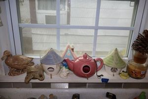 lot 209 image: Ceramic bird houses, candles, and figurines