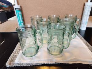 lot 124 image: Selection of 7 collectible Coca Cola heavy glass mugs