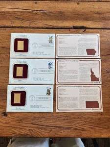 lot 89 image: Selection of 3 - First Day of Issue collectible postal cover and gold plated stamp featuring state bird and flower - Iowa, Idaho, and Kansas