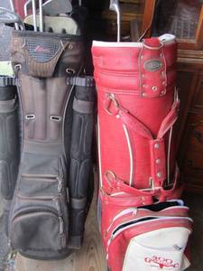 lot 200 image: red burton golf bag with gold clubs, brown datrek golf bag with golf clubs