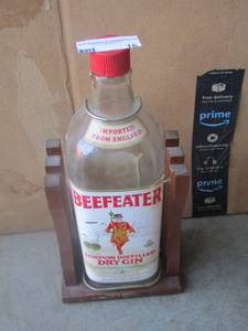 lot 16 image: large beefeater london distilled dry gin liquor bottle in cradle
