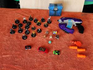 lot 11 image: Selection of collectible toys - HeroClix figures, Gundam figures, Nerf, How Wheels, Magic Cards and dice
