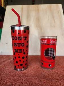 lot 117 image: Coca Cola and Lady Bug collectible plastic glass and ladybug themed metal tumbler and straw