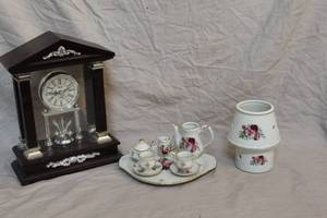 lot 51 image: miniature porcelain tea set with matching warmer and clock
