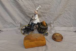 lot 68 image: Chef Bicycling his arm is broken see pictures fake bread and bagel and 2- candle holders