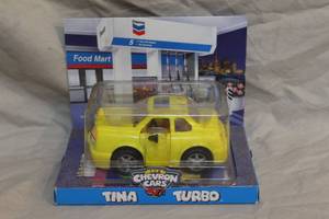 lot 165 image: 1998 yellow plastic Chevron Cars Tina Turbo toy car. The item is an original collectible piece and comes in its original packaging.