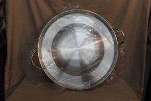 lot 228 image: stainless steel concave comal, also known as a pozo griddle or wok.  Used for cooking tortillas, searing meats, and other outdoor dishes.