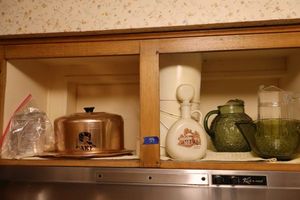 lot 59 image: Glass pitchers, vintage decanter, and copper cake holder