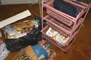 lot 105 image: Plastic rolling cart with craft supplies (vintage sewing patterns)