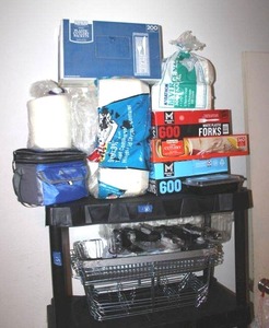 lot 130 image: Paper plates and wire food warmer trays, lunch cooler, and plastic ware