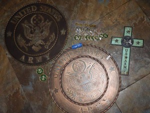 lot 32 image: US Army themed lot metal signs, keychains and decorative cross