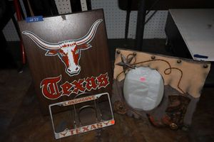 lot 55 image: Texas Longhorns wall art, license plate cover, plus Western photo frame
