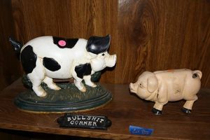 lot 85 image: Cast iron pig door stop and piggy bank