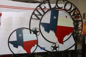 lot 67 image: Two Texas shape metal circle signs