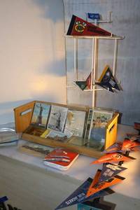 lot 144 image: Vintage postcards, small ice hockey pennants, and wire display rack